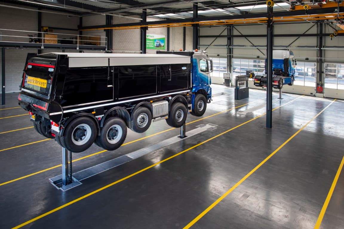 truck lifted with the Stertil-Koni in-ground piston vehicle lift in a workshop maintenance, repair and inspection