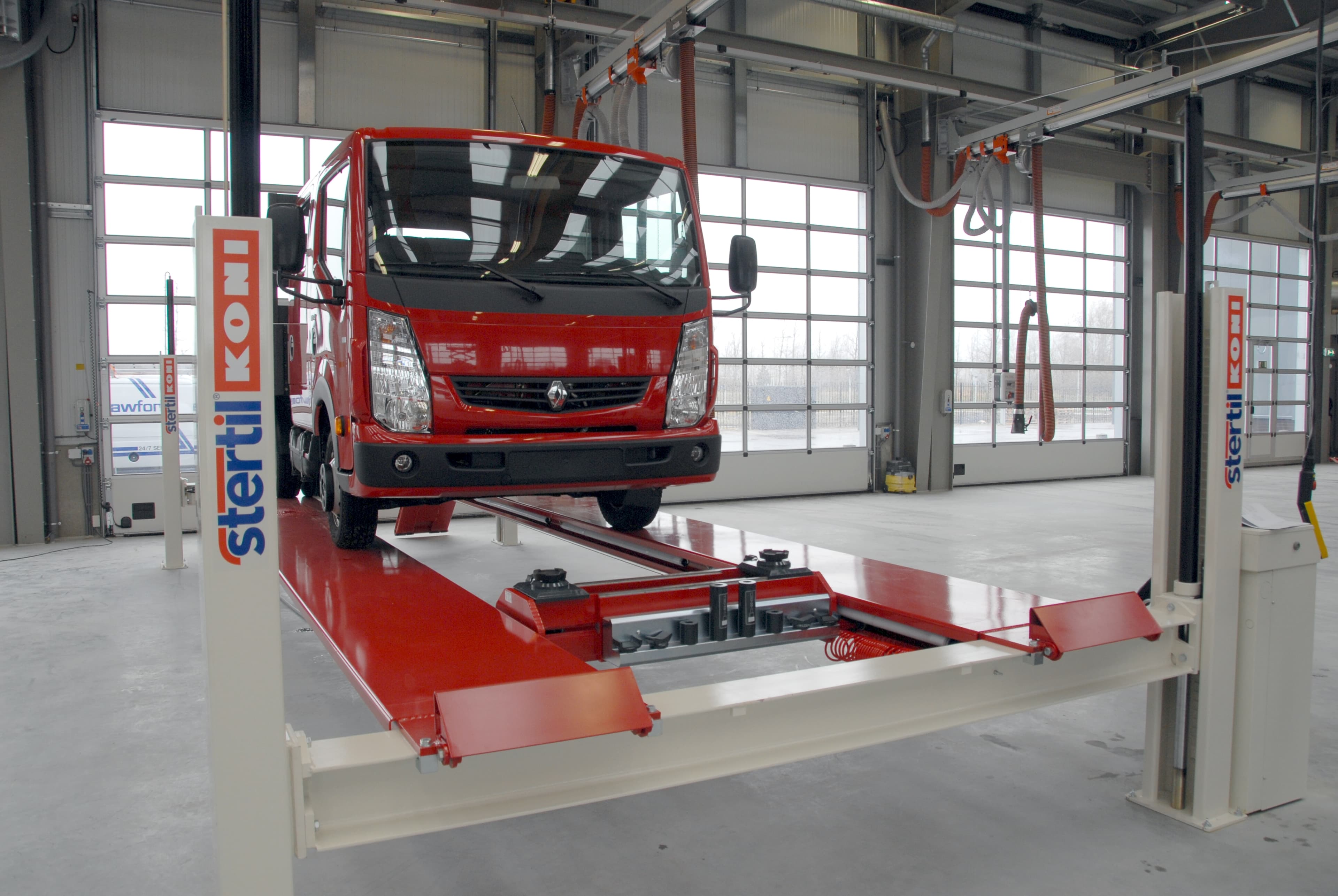 Renault truck lifted on the Stertil-Koni 4-post vehicle lift in a workshop for maintenance and repair