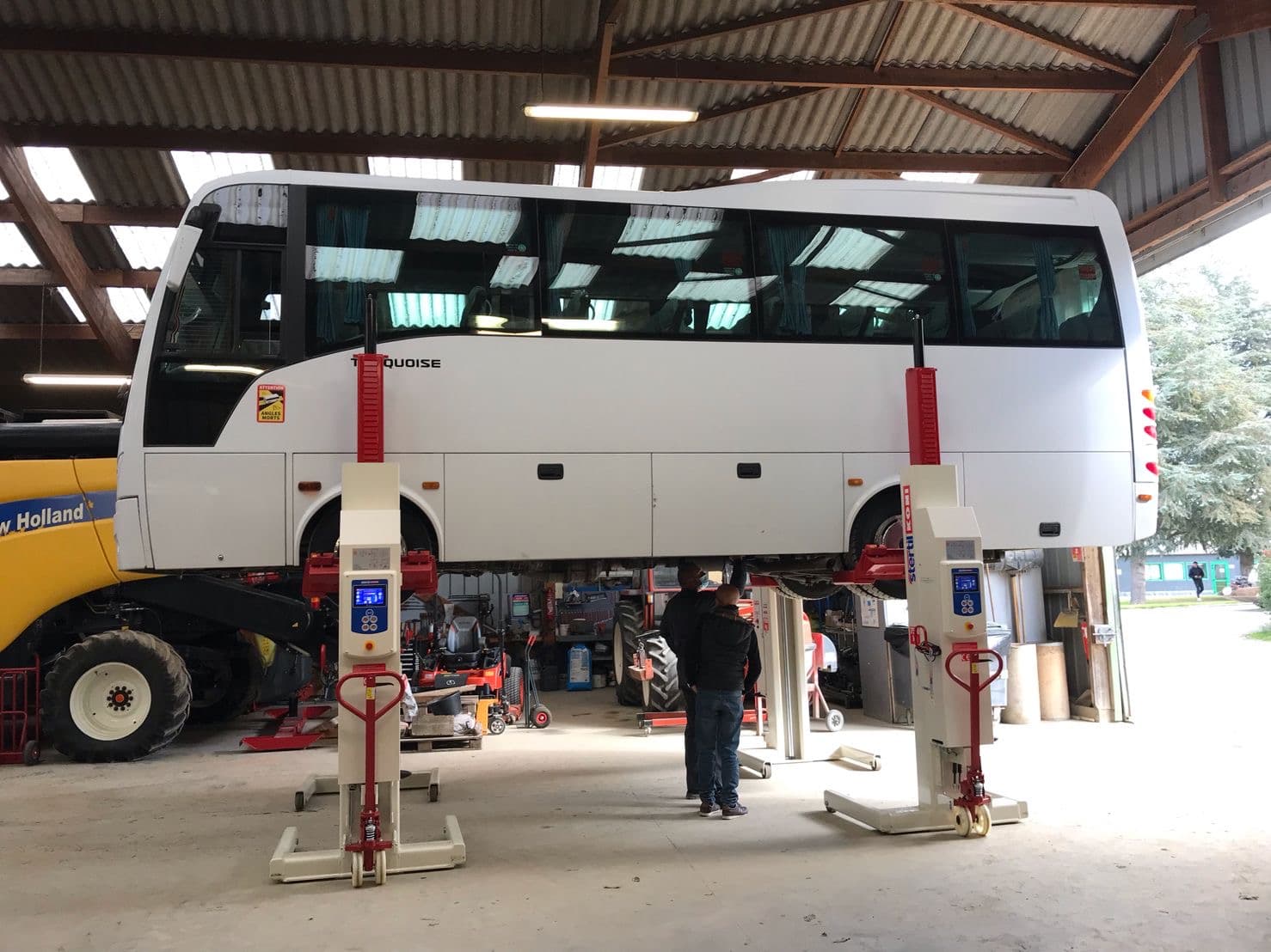 public transport bus lifted with mobile column vehicle lifts from Stertil-Koni in a workshop for maintenance, repair and inspection