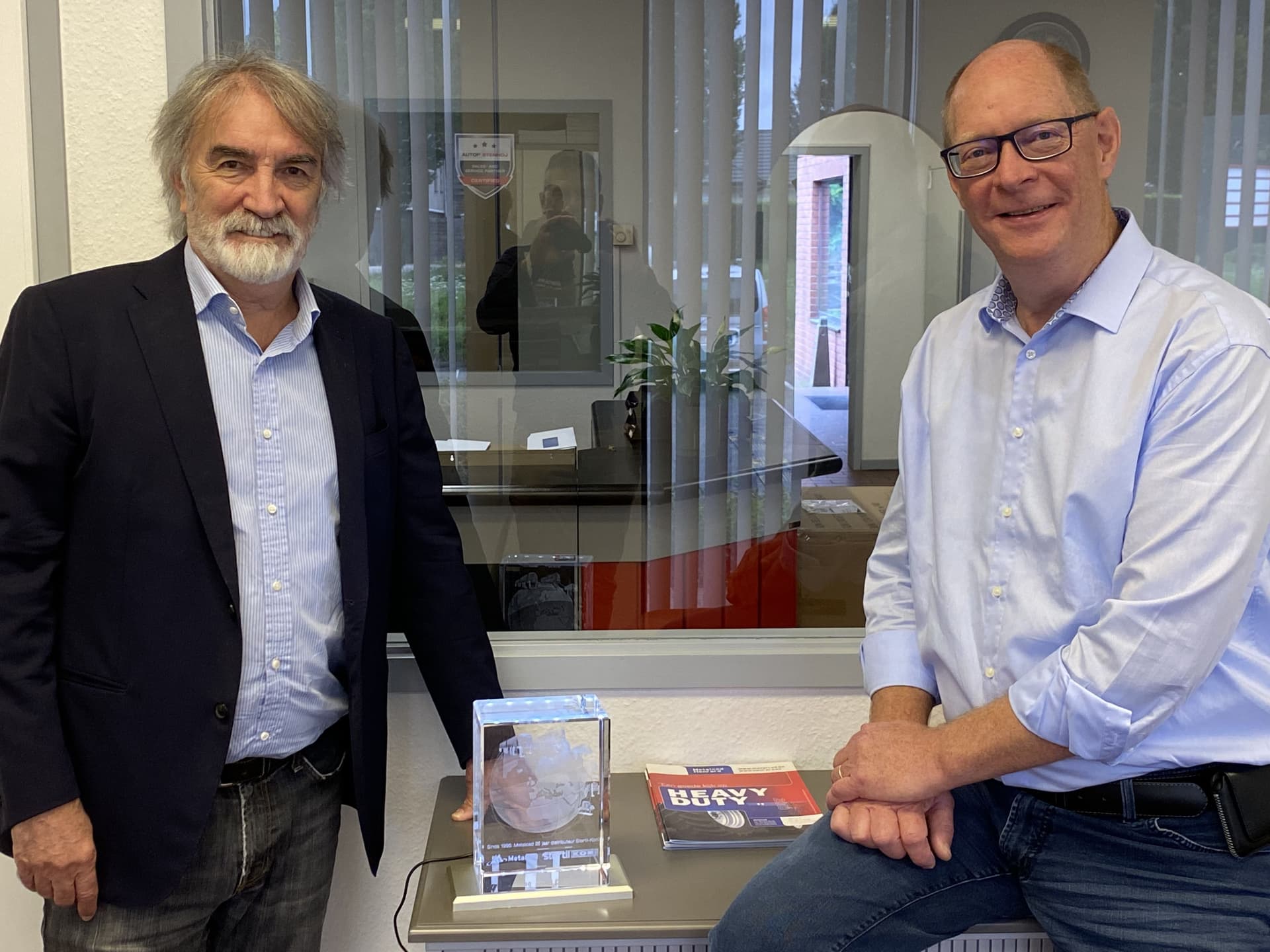 Rudi Van Gael, Director and Owner of Metalced (left), and Peter Van Weert, Commercial Director, receive anniversary momento from Stertil-Koni.
